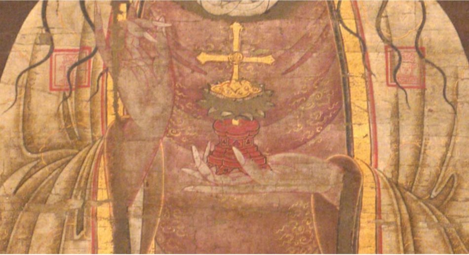 A close-up of a painting of the torso of a person wearing robes and holding a ball with a cross on it.