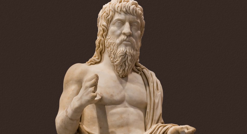 A marble statue of the upper half of a bearded man, half-clothed in a robe.